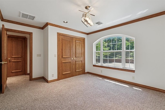 12700 Jabez Rd, Edmond, OK 73013 - unfurnished bedroom featuring a closet, ornamental molding, and carpet floors