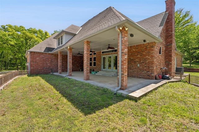 12700 Jabez Rd, Edmond, OK 73013 - back of house featuring ceiling fan, a fenced backyard, brick siding, and roof with shingles
