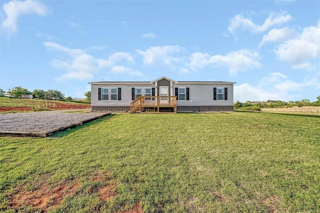 back of house with a wooden deck and a yard