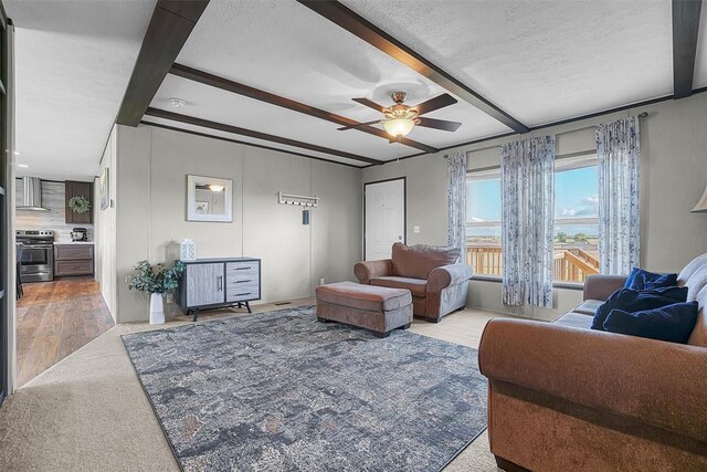 10284 N 2128, Foss, OK 73647 - living room with a ceiling fan, beam ceiling, a textured ceiling, and carpet