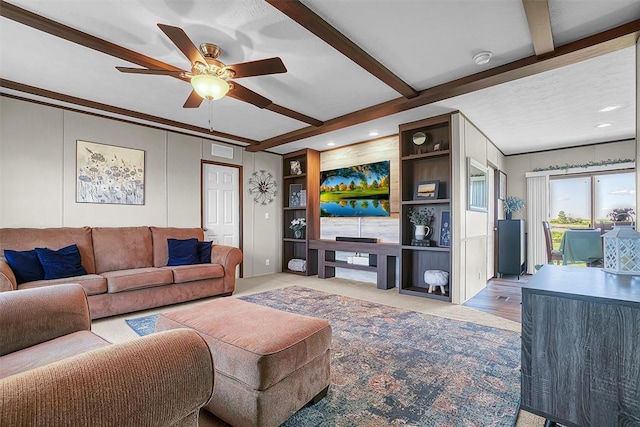 10284 N 2128, Foss, OK 73647 - living area with a ceiling fan, ornamental molding, beamed ceiling, a decorative wall, and carpet