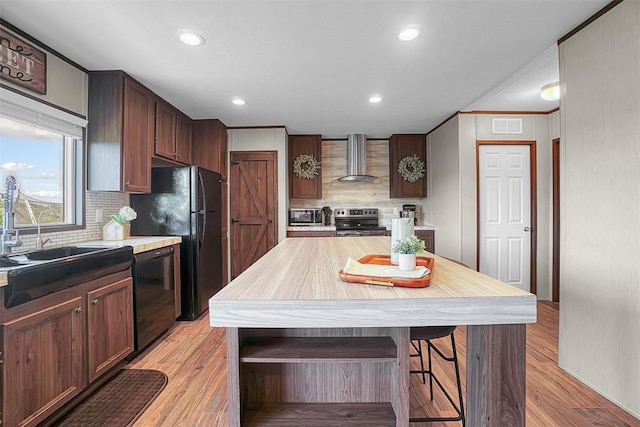 10284 N 2128, Foss, OK 73647 - kitchen with black appliances, wall chimney range hood, tasteful backsplash, recessed lighting, and light countertops