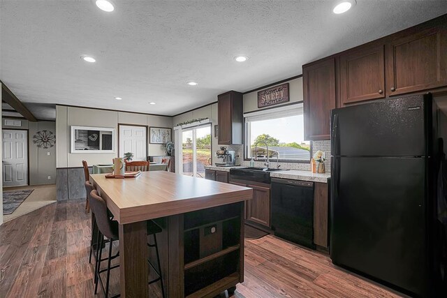 10284 N 2128, Foss, OK 73647 - kitchen with black appliances, butcher block counters, a sink, recessed lighting, and decorative backsplash