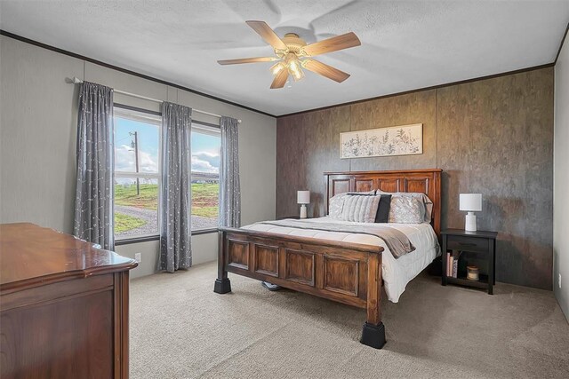 10284 N 2128, Foss, OK 73647 - bedroom featuring light carpet, a ceiling fan, wood walls, and a textured ceiling