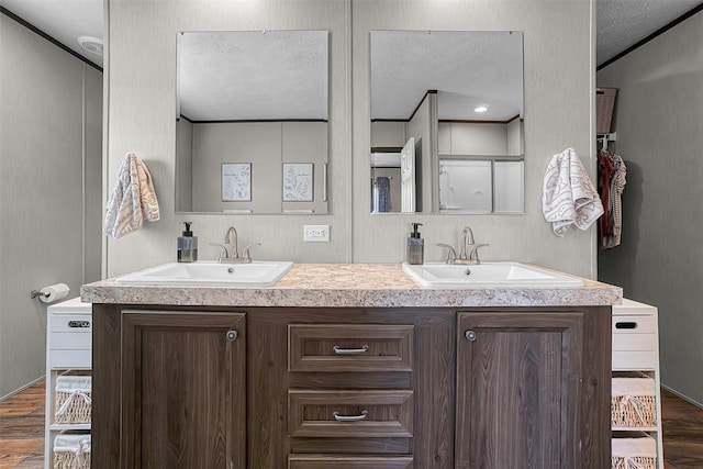10284 N 2128, Foss, OK 73647 - full bath with wood finished floors, double vanity, and a textured ceiling