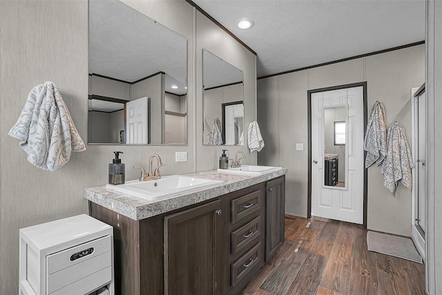 10284 N 2128, Foss, OK 73647 - full bathroom with a textured ceiling, wood finished floors, and double vanity