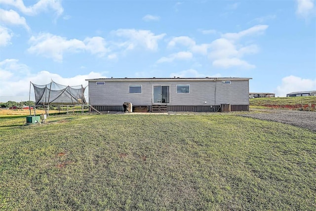 10284 N 2128, Foss, OK 73647 - back of house featuring entry steps, a lawn, and a trampoline