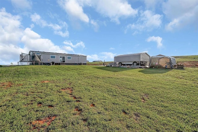 10284 N 2128, Foss, OK 73647 - view of grassy yard with a detached carport and a trampoline