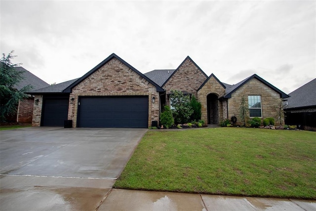 view of front of house featuring a garage, concrete driveway, and a front lawn