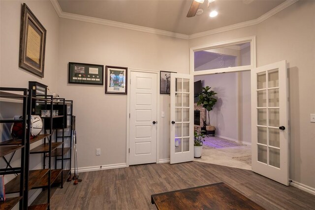 foyer entrance with french doors, wood finished floors, ornamental molding, baseboards, and ceiling fan