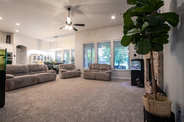carpeted living area featuring ceiling fan, a fireplace, recessed lighting, and baseboards