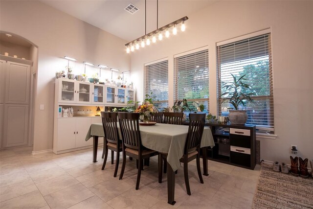 dining space with a towering ceiling
