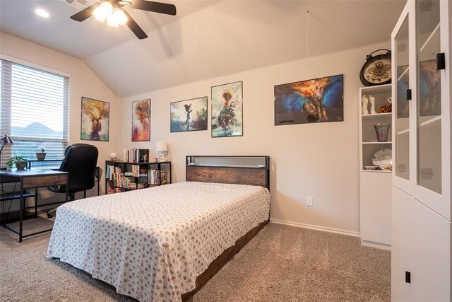 bedroom with carpet floors, vaulted ceiling, baseboards, an office area, and a ceiling fan