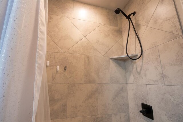 bathroom view of tiled shower