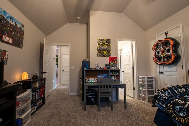 carpeted home office with vaulted ceiling