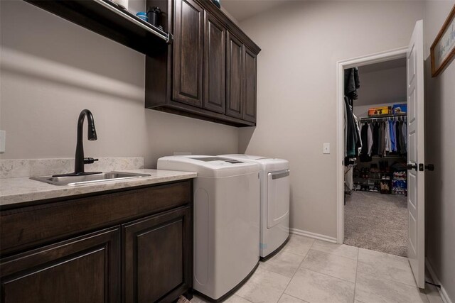 laundry room with cabinet space, independent washer and dryer, light tile patterned floors, baseboards, and light carpet