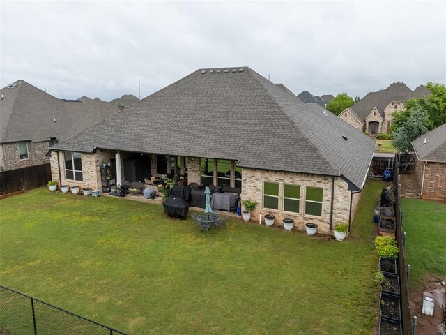 rear view of house with a shingled roof