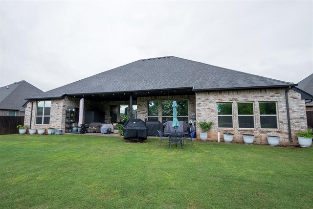 back of property featuring roof with shingles and brick siding