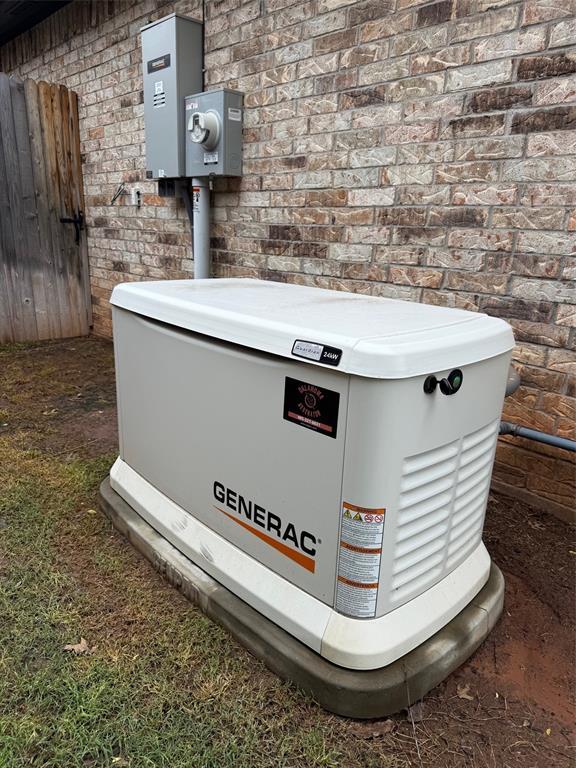 exterior view of a power unit, electric meter, and brick siding