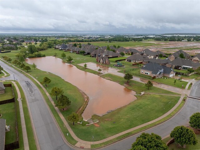 view of property location with a nearby body of water and nearby suburban area