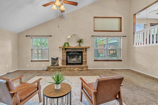 carpeted living room featuring baseboards, a ceiling fan, high vaulted ceiling, and a brick fireplace