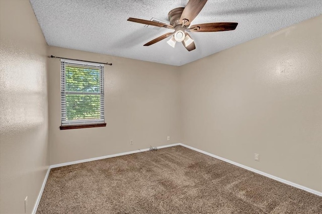 carpeted spare room featuring baseboards, a ceiling fan, and a textured ceiling