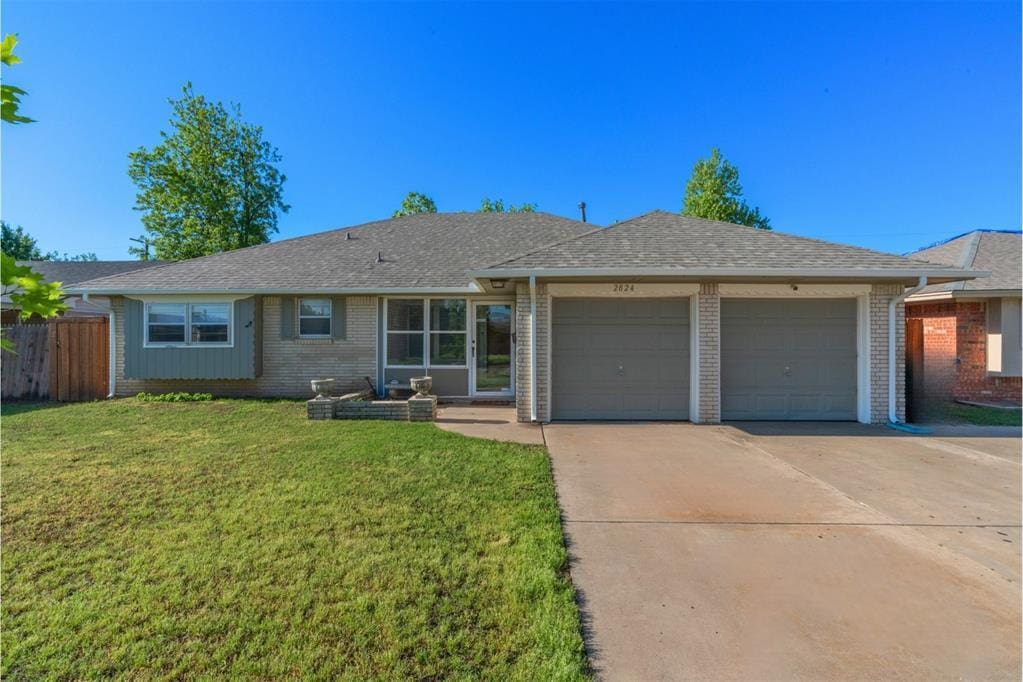 ranch-style house with a front yard, brick siding, fence, concrete driveway, and an attached garage