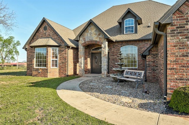 4495 SE 37th St, Norman, OK 73072 - view of front facade featuring a front lawn, brick siding, a shingled roof, and stone siding