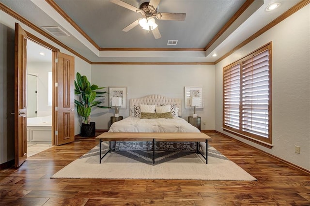 4495 SE 37th St, Norman, OK 73072 - bedroom with crown molding, wood finished floors, a raised ceiling, ensuite bathroom, and recessed lighting