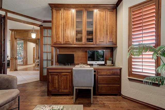 4495 SE 37th St, Norman, OK 73072 - office with built in study area, ornamental molding, dark wood finished floors, and a textured wall