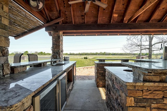 4495 SE 37th St, Norman, OK 73072 - view of patio with an outdoor kitchen, beverage cooler, and a ceiling fan