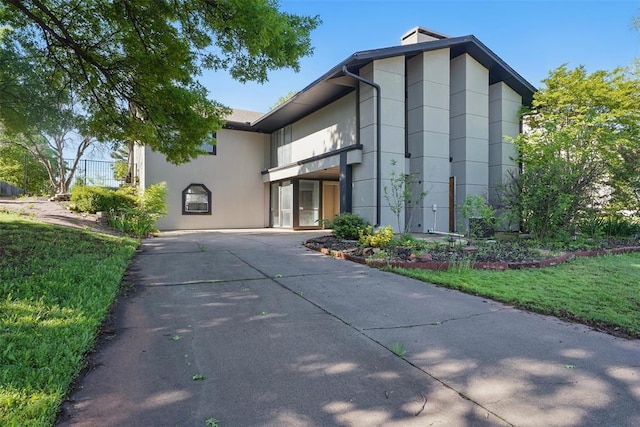 3408 Partridge Rd, Oklahoma City, OK 73120 - view of side of home with stucco siding and a yard