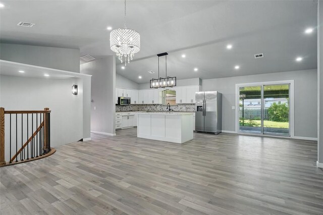 3408 Partridge Rd, Oklahoma City, OK 73120 - kitchen with an inviting chandelier, lofted ceiling, baseboards, open floor plan, and stainless steel appliances