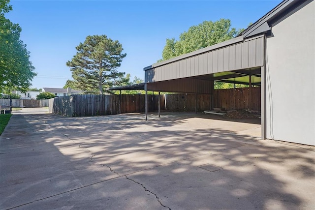 3408 Partridge Rd, Oklahoma City, OK 73120 - view of patio / terrace with concrete driveway, fence, and a carport
