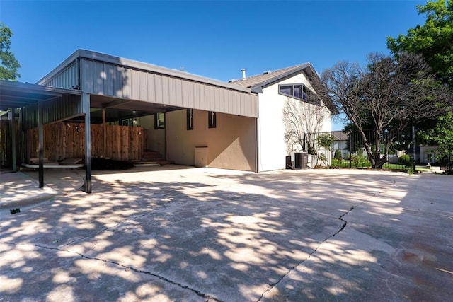 3408 Partridge Rd, Oklahoma City, OK 73120 - back of house featuring stucco siding, fence, and driveway