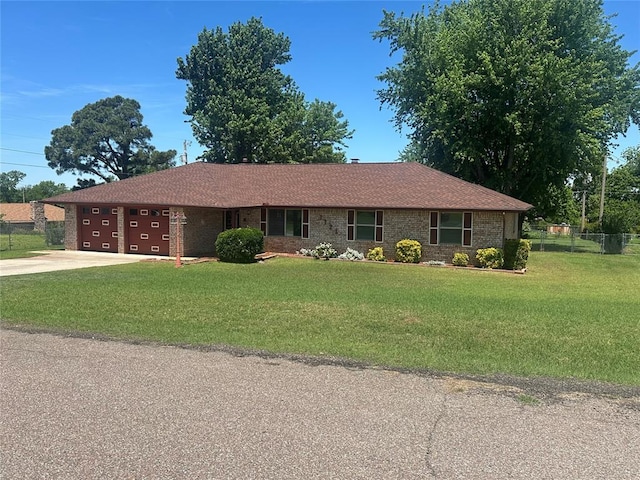 1721 E Ridgeview Ter, Mustang, OK 73064 - ranch-style house with concrete driveway, an attached garage, fence, and a front lawn