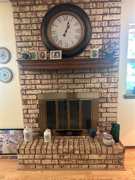 1721 E Ridgeview Ter, Mustang, OK 73064 - interior details with a brick fireplace and wood finished floors