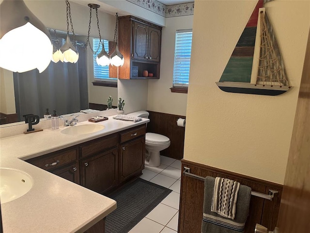 1721 E Ridgeview Ter, Mustang, OK 73064 - full bath with wooden walls, tile patterned flooring, vanity, toilet, and a wainscoted wall