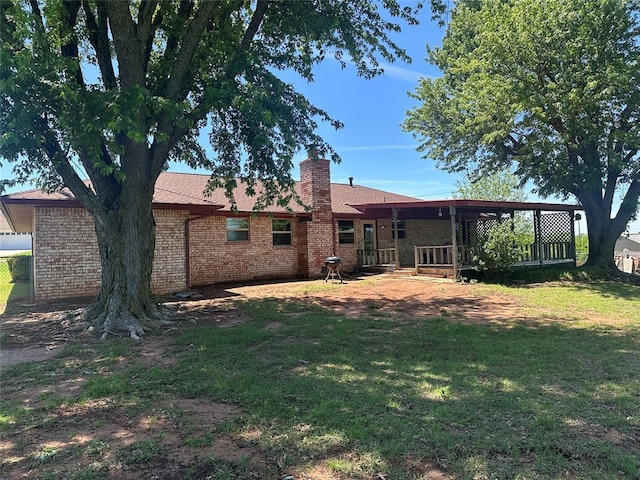 1721 E Ridgeview Ter, Mustang, OK 73064 - back of house featuring a lawn, brick siding, and a chimney