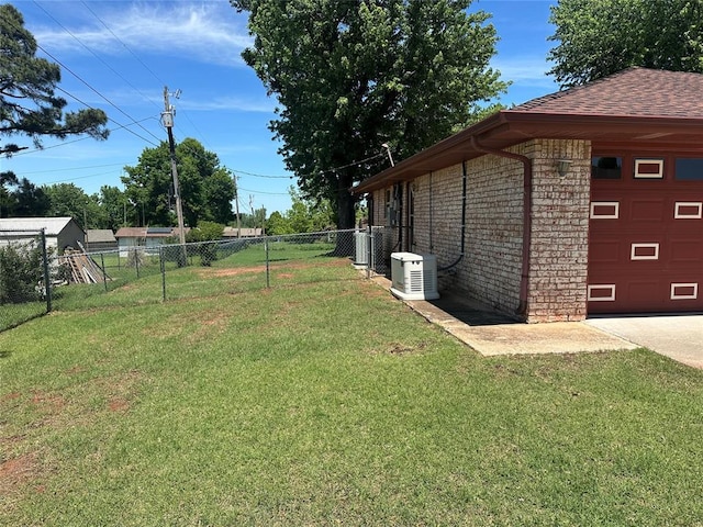 1721 E Ridgeview Ter, Mustang, OK 73064 - view of yard with an attached garage, central AC unit, fence, and driveway