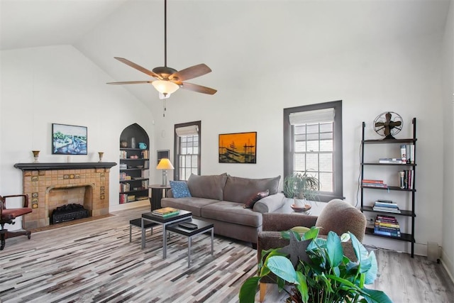 1912 NW 22nd St, Oklahoma City, OK 73106 - living area with wood finished floors, high vaulted ceiling, a ceiling fan, and a tile fireplace