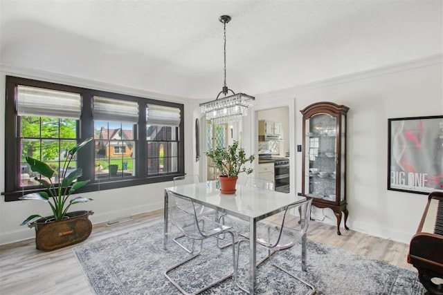 1912 NW 22nd St, Oklahoma City, OK 73106 - home office featuring light wood-style flooring and a chandelier