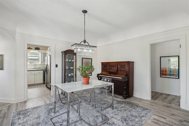 1912 NW 22nd St, Oklahoma City, OK 73106 - dining room featuring a chandelier and light wood-type flooring