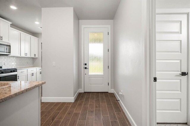 2375 Clubhouse Dr, Blanchard, OK 73010 - doorway with baseboards, recessed lighting, and dark wood-type flooring