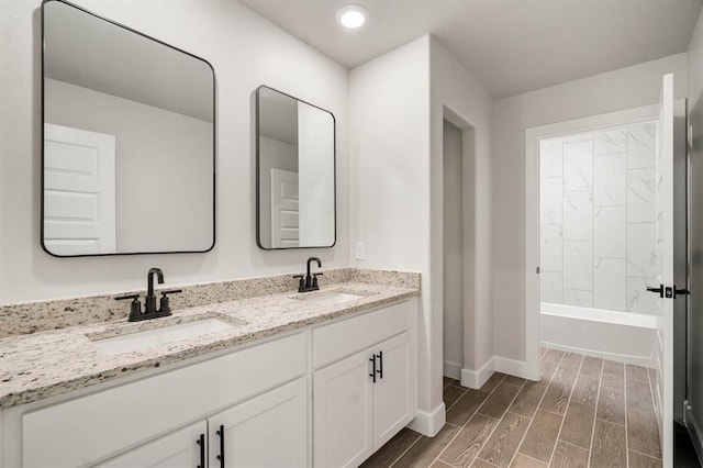 2375 Clubhouse Dr, Blanchard, OK 73010 - bathroom featuring baseboards, double vanity, wood finish floors, and a sink