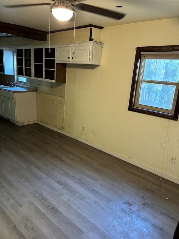 kitchen featuring white cabinetry, baseboards, open shelves, and dark wood-type flooring