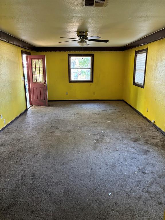 unfurnished room with carpet floors, ceiling fan, and baseboards