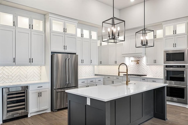 2217 Winter Creek Blvd, Blanchard, OK 73010 - kitchen featuring a sink, decorative backsplash, appliances with stainless steel finishes, and wine cooler