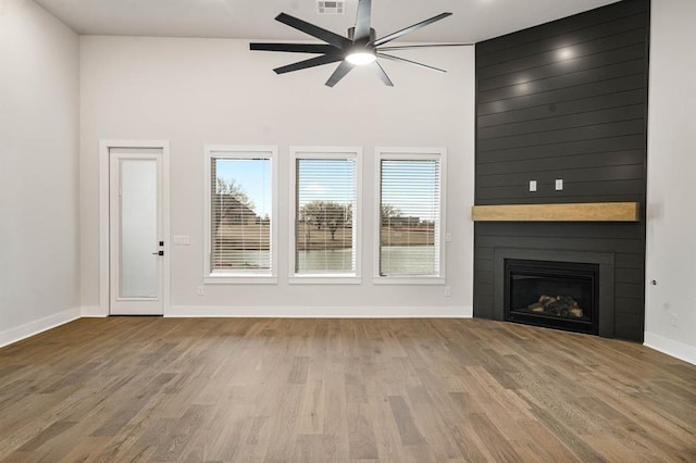 2217 Winter Creek Blvd, Blanchard, OK 73010 - unfurnished living room with a ceiling fan, baseboards, a wealth of natural light, and wood finished floors