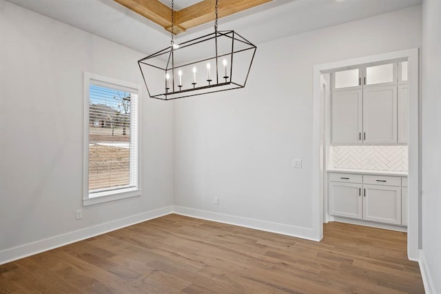 2217 Winter Creek Blvd, Blanchard, OK 73010 - unfurnished dining area featuring baseboards, a chandelier, and light wood-style flooring